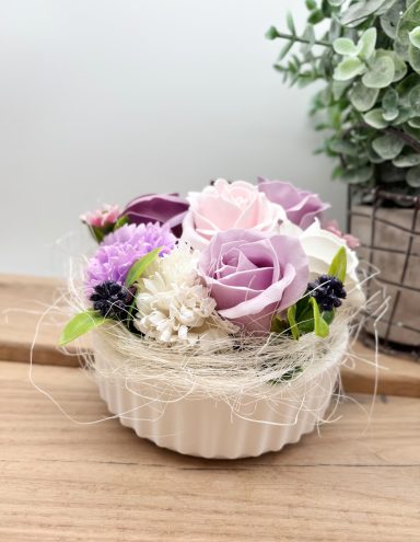 Weiße Schale gefüllt mit Rosen in weiß und lila